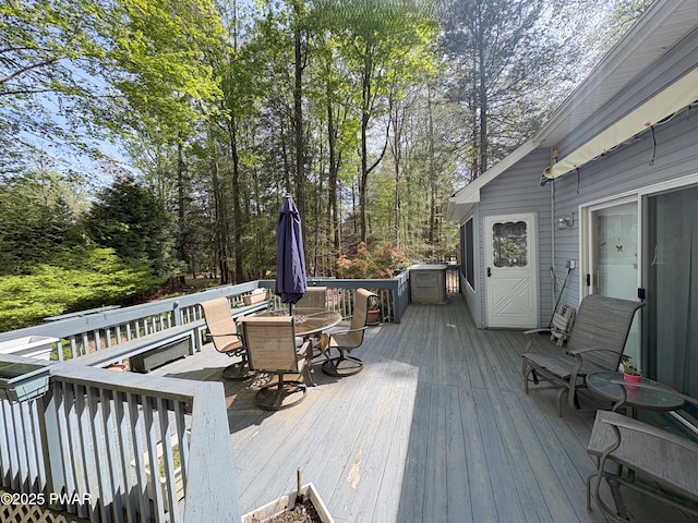 wooden terrace featuring outdoor dining area