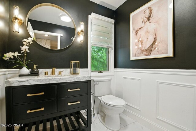 202 Remuda Dr, Lords Valley, PA 18428 - bathroom with wainscoting, vanity, a decorative wall, and marble look tiles
