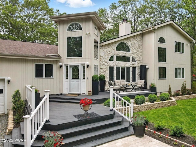 202 Remuda Dr, Lords Valley, PA 18428 - back of house featuring a chimney, roof with shingles, stone siding, and a lawn
