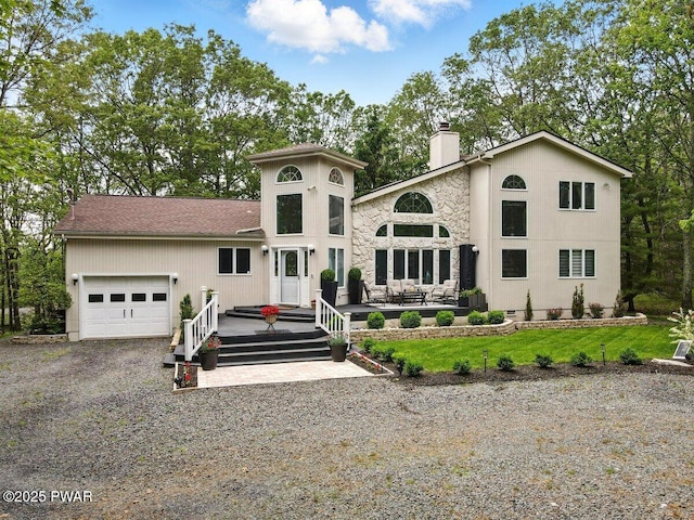 202 Remuda Dr, Lords Valley, PA 18428 - view of front of property with a chimney, an attached garage, driveway, and stone siding