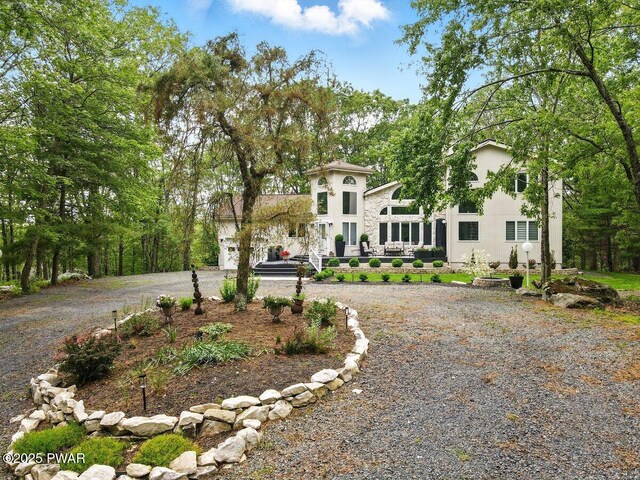 202 Remuda Dr, Lords Valley, PA 18428 - view of front of house featuring stucco siding and curved driveway