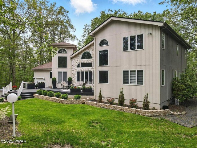 202 Remuda Dr, Lords Valley, PA 18428 - back of property with a lawn, an outdoor living space, a patio area, and a garage