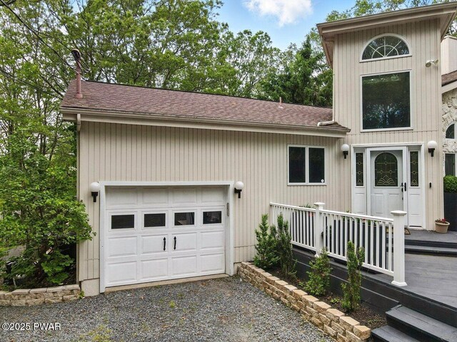 202 Remuda Dr, Lords Valley, PA 18428 - view of side of home with roof with shingles, driveway, and an attached garage