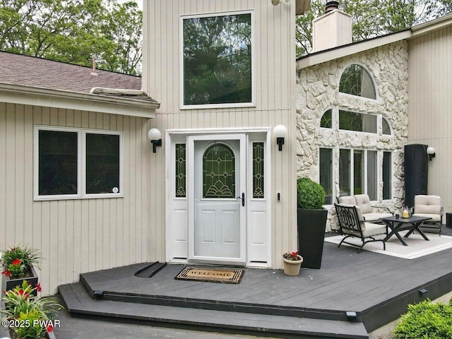 202 Remuda Dr, Lords Valley, PA 18428 - doorway to property with a chimney, a deck, and outdoor lounge area