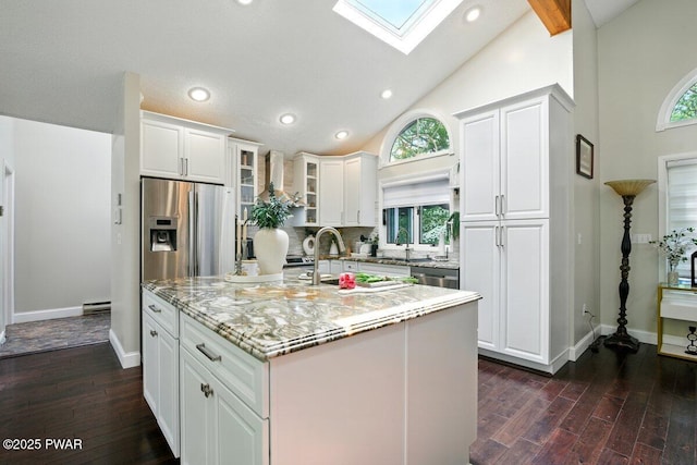 202 Remuda Dr, Lords Valley, PA 18428 - kitchen featuring a skylight, white cabinetry, dark wood finished floors, glass insert cabinets, and light stone countertops