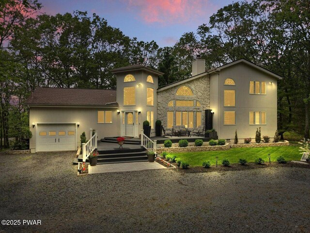 202 Remuda Dr, Lords Valley, PA 18428 - mediterranean / spanish-style home featuring a chimney, an attached garage, driveway, and stone siding