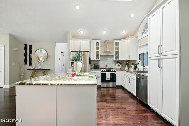 202 Remuda Dr, Lords Valley, PA 18428 - kitchen featuring stainless steel appliances, wall chimney range hood, a center island with sink, backsplash, and dark wood-type flooring