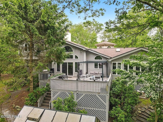 202 Remuda Dr, Lords Valley, PA 18428 - rear view of house with stairway, an outdoor hangout area, a chimney, and a wooden deck