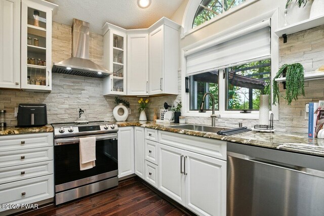 202 Remuda Dr, Lords Valley, PA 18428 - kitchen featuring appliances with stainless steel finishes, wall chimney exhaust hood, plenty of natural light, stone counters, and a textured ceiling