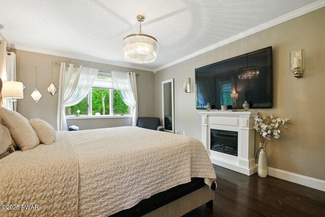 202 Remuda Dr, Lords Valley, PA 18428 - bedroom featuring wood finished floors, a chandelier, crown molding, and a glass covered fireplace