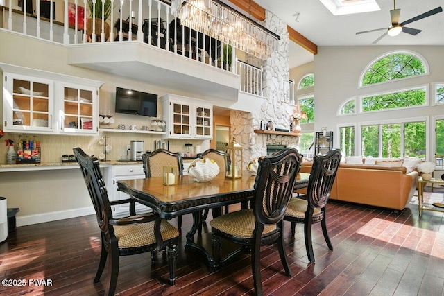 202 Remuda Dr, Lords Valley, PA 18428 - dining area with a ceiling fan, high vaulted ceiling, dark wood-type flooring, a fireplace, and beamed ceiling