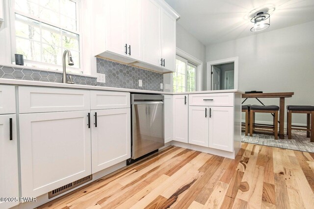 209 Conashaugh Trl, Milford, PA 18337 - kitchen featuring stainless steel dishwasher, light wood-type flooring, decorative backsplash, and white cabinets
