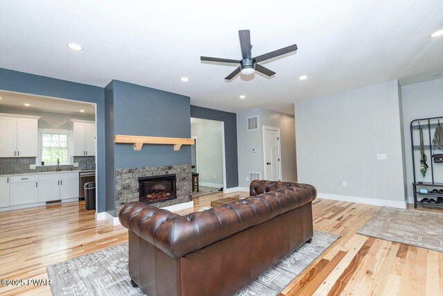 209 Conashaugh Trl, Milford, PA 18337 - living room with light wood-style floors, a ceiling fan, a fireplace, and recessed lighting