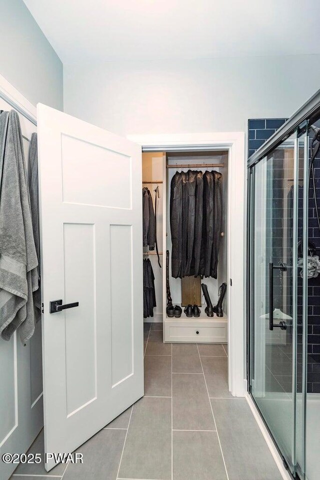 209 Conashaugh Trl, Milford, PA 18337 - full bath featuring tile patterned flooring, a shower stall, and a walk in closet