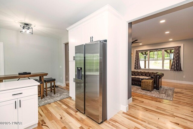 209 Conashaugh Trl, Milford, PA 18337 - kitchen with stainless steel fridge, light wood-style floors, white cabinetry, recessed lighting, and light countertops