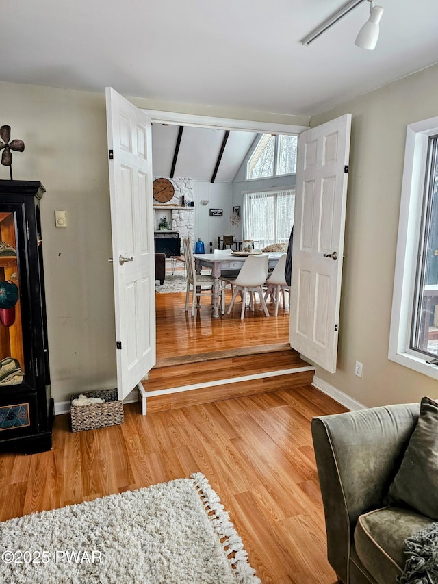 interior space featuring hardwood / wood-style flooring, vaulted ceiling, and ceiling fan