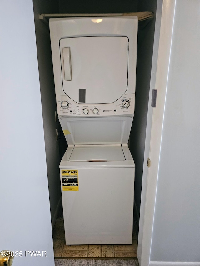 laundry room with stacked washer / drying machine