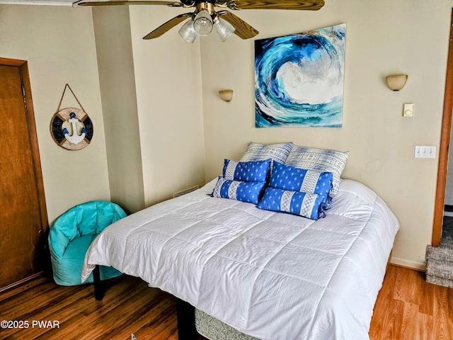 bedroom featuring hardwood / wood-style flooring and ceiling fan