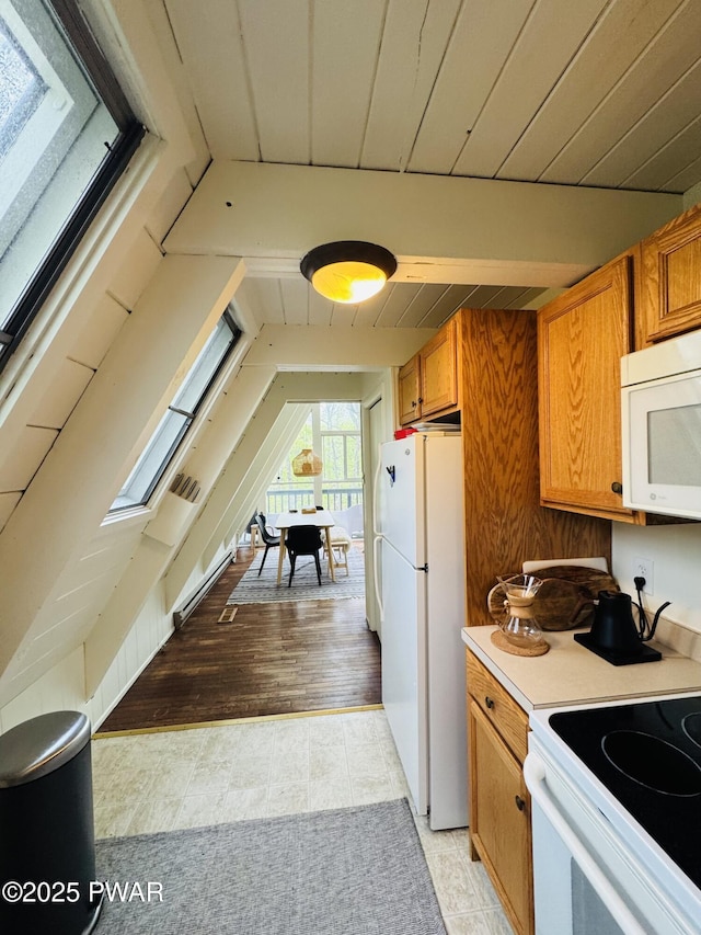124 Granite Dr, Lords Valley, PA 18428 - kitchen featuring white appliances, brown cabinets, light countertops, lofted ceiling, and light tile patterned floors