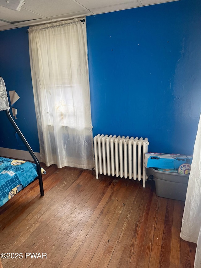 bedroom with radiator and wood-type flooring