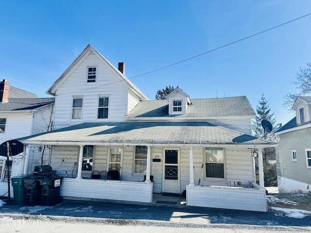 view of property featuring covered porch