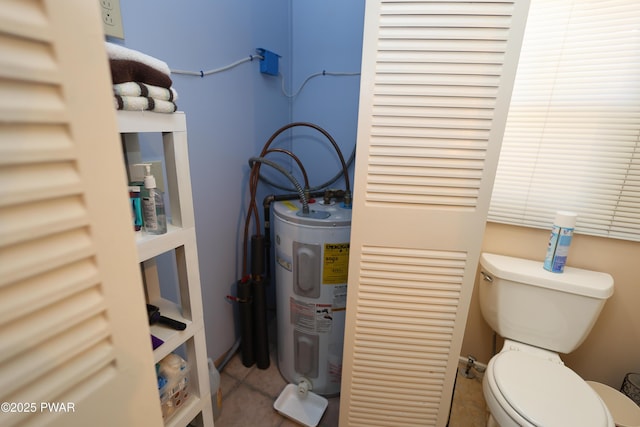 bathroom with tile patterned flooring, toilet, and electric water heater