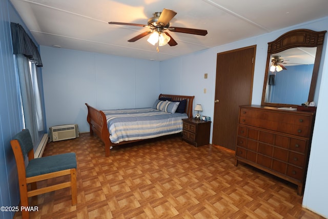 bedroom with baseboard heating, a ceiling fan, and a wall mounted AC