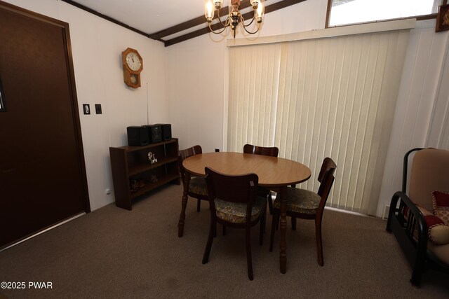 carpeted dining room featuring beam ceiling and a chandelier