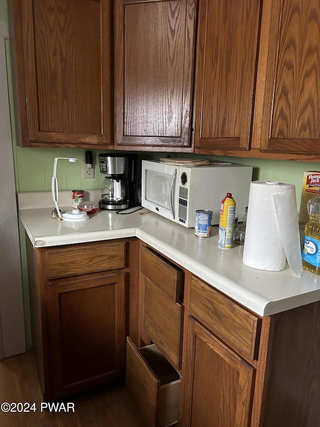 kitchen featuring tasteful backsplash and dark hardwood / wood-style flooring