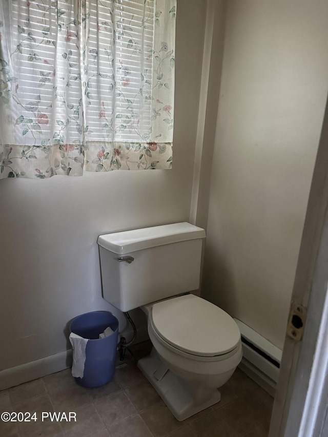 bathroom featuring baseboard heating, tile patterned floors, and toilet