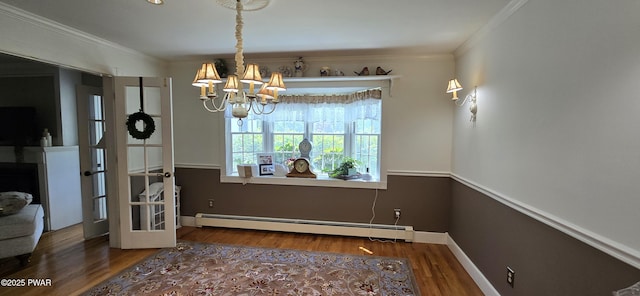 300 W High St, Milford, PA 18337 - dining room featuring a baseboard heating unit, a chandelier, wood finished floors, and crown molding