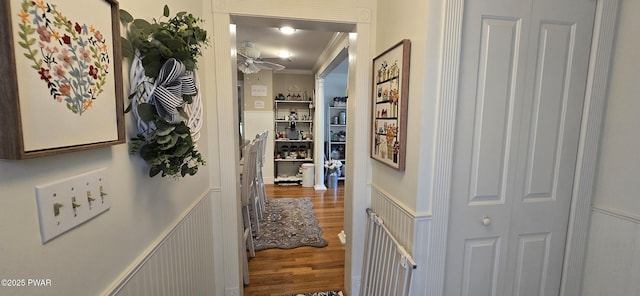 300 W High St, Milford, PA 18337 - hallway with wood finished floors, wainscoting, crown molding, and a decorative wall