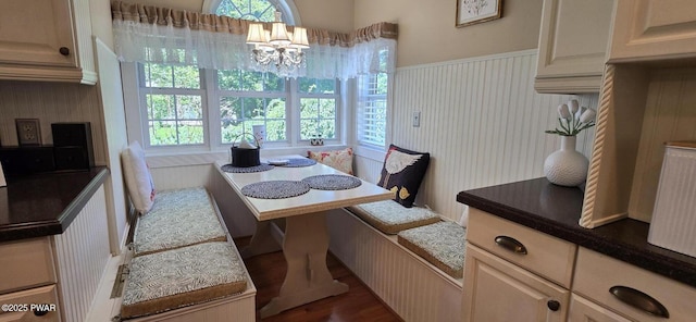 300 W High St, Milford, PA 18337 - dining room featuring breakfast area, a chandelier, dark wood finished floors, and wainscoting