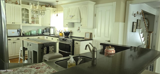 300 W High St, Milford, PA 18337 - kitchen featuring electric range, custom exhaust hood, crown molding, dark countertops, and glass insert cabinets