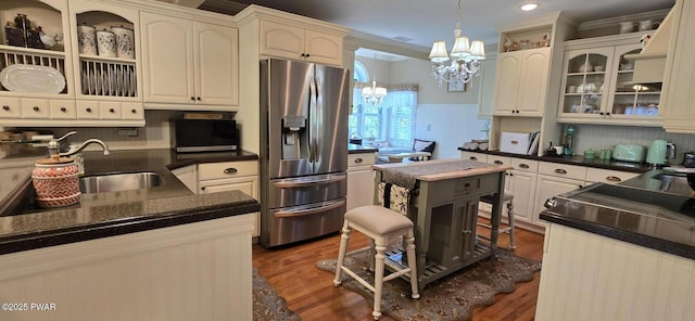 300 W High St, Milford, PA 18337 - kitchen with stainless steel refrigerator with ice dispenser, a chandelier, wood finished floors, dark countertops, and hanging light fixtures