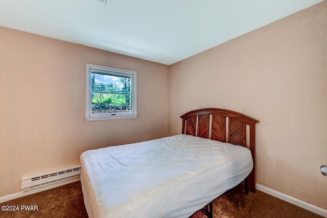 bedroom with a baseboard radiator and dark carpet