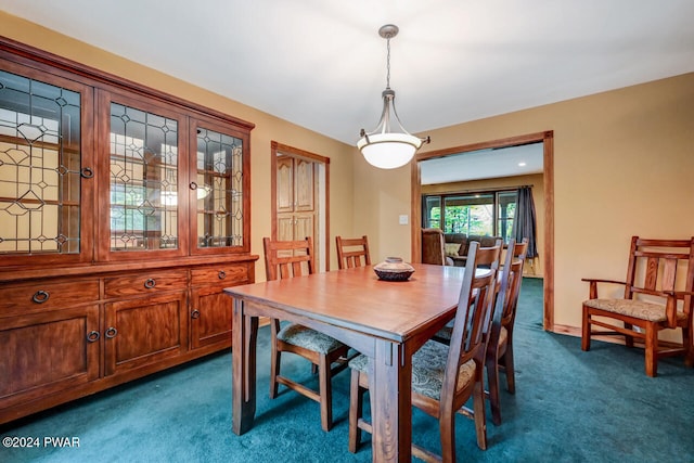 dining area with dark colored carpet