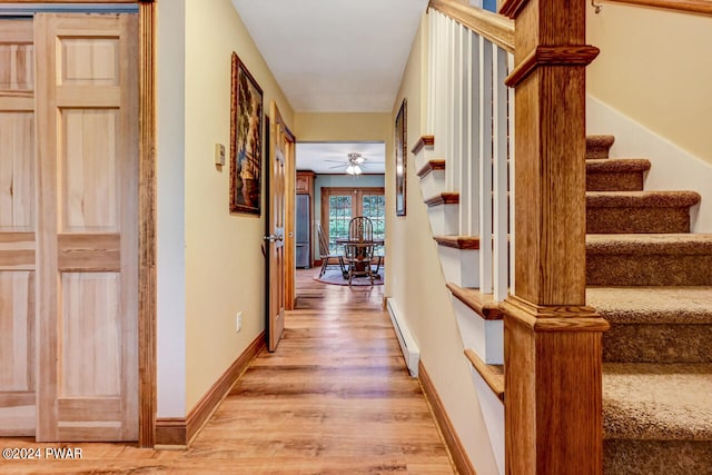 hall with hardwood / wood-style floors and a baseboard heating unit