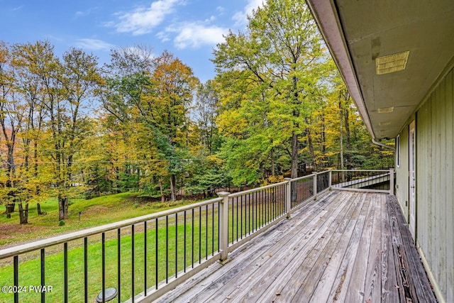 wooden deck with a lawn