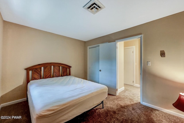 carpeted bedroom with a closet