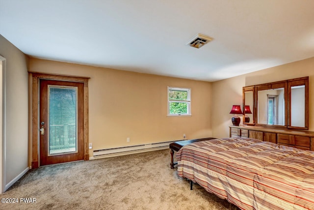 bedroom with light carpet and a baseboard heating unit