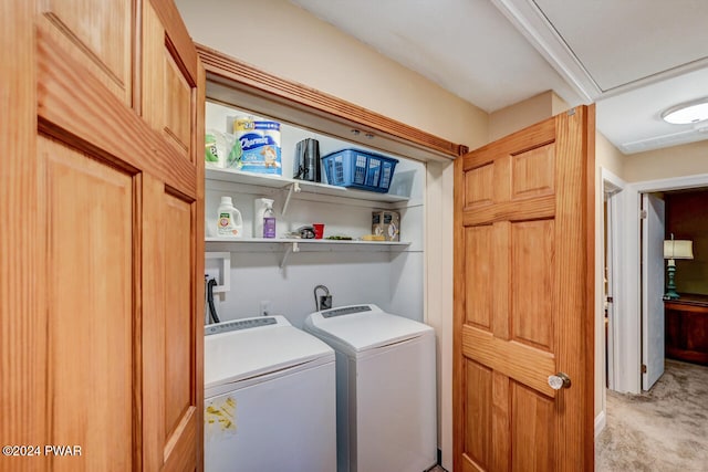 laundry area featuring light carpet and separate washer and dryer