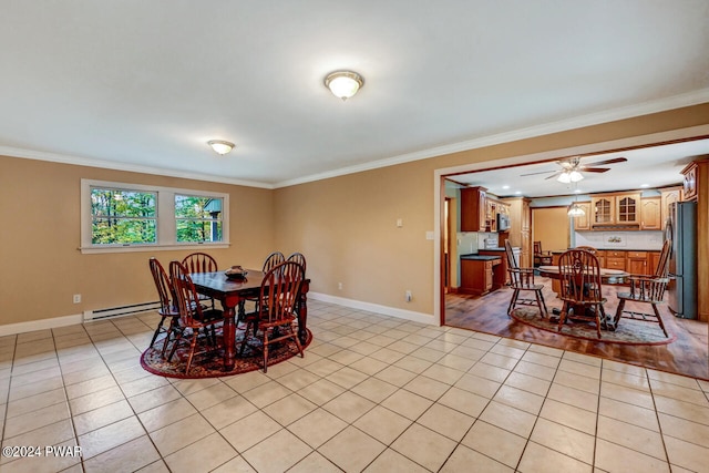 dining space with light tile patterned floors, a baseboard heating unit, and crown molding