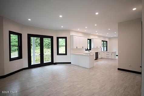 kitchen featuring recessed lighting, white cabinets, a peninsula, and light countertops