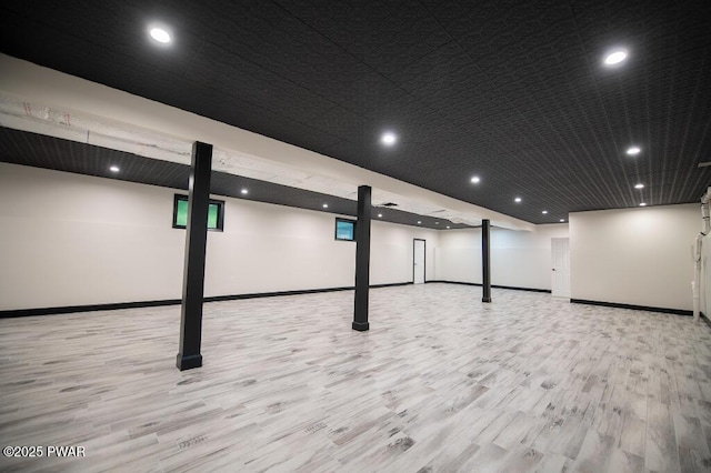 finished basement with recessed lighting, wood finished floors, and baseboards