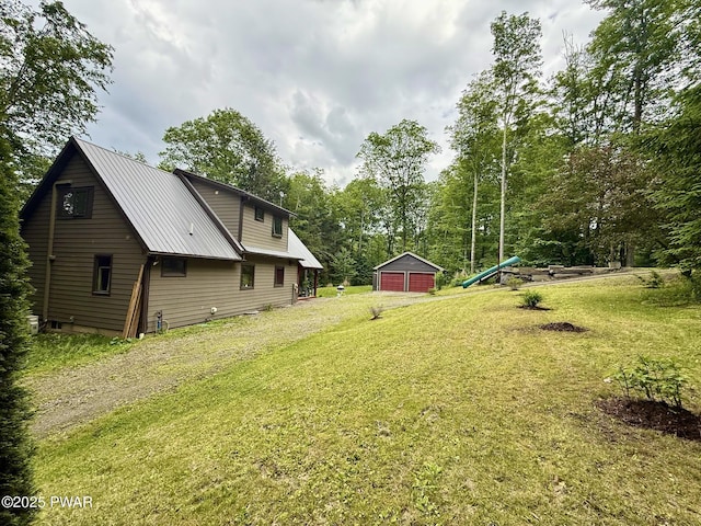 498 Penn York Rd, Starlight, PA 18461 - view of grassy yard with an outbuilding, a garage, and view of wooded area