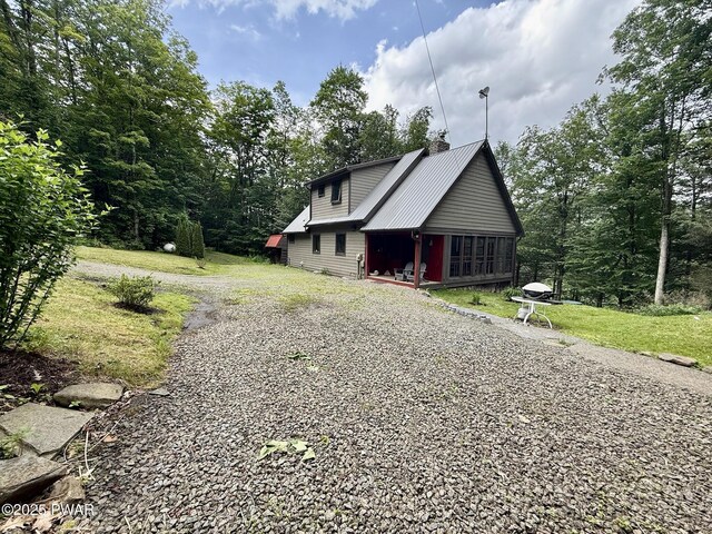498 Penn York Rd, Starlight, PA 18461 - view of side of property with a chimney, driveway, and a yard