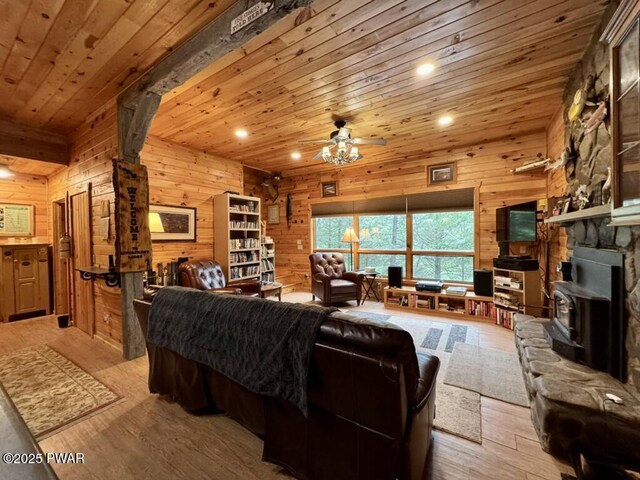 498 Penn York Rd, Starlight, PA 18461 - living room featuring wood walls, a ceiling fan, a wood stove, recessed lighting, and wood ceiling