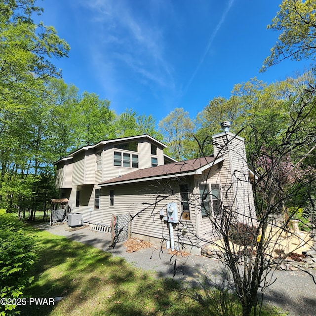 344 Canoebrook Dr, Lords Valley, PA 18428 - rear view of house with a chimney and roof with shingles
