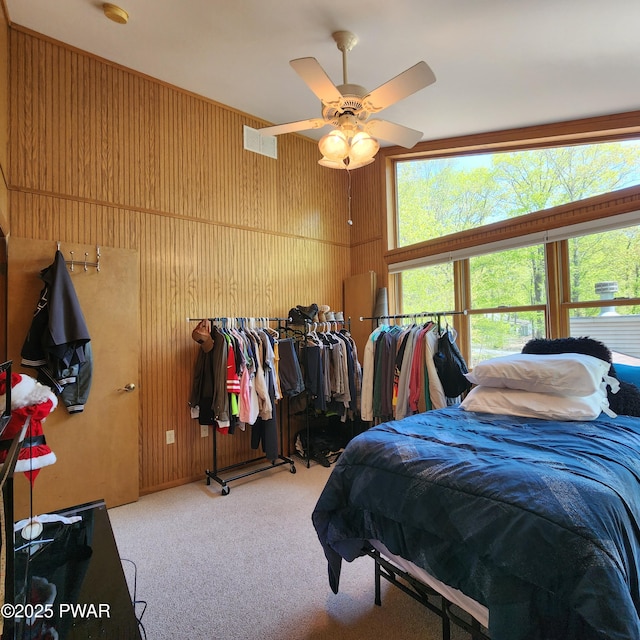344 Canoebrook Dr, Lords Valley, PA 18428 - bedroom featuring carpet flooring, wood walls, and a ceiling fan